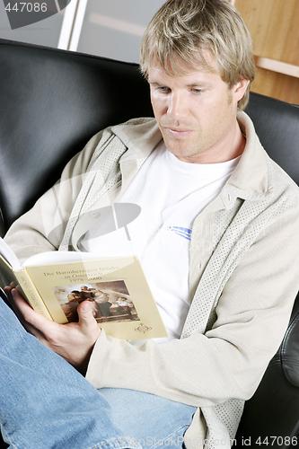 Image of Mid adult man with book