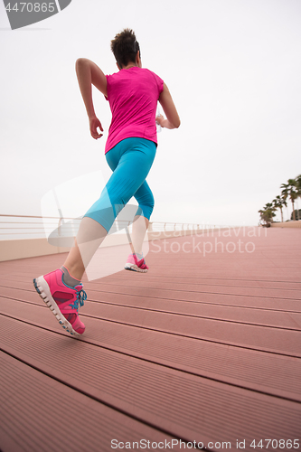 Image of woman busy running on the promenade