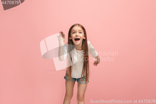 Image of Beautiful female half-length portrait on pink studio backgroud. The young emotional teen girl