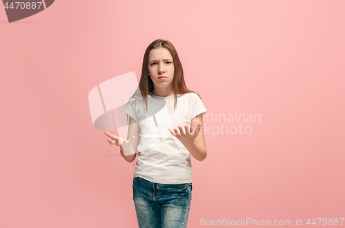 Image of Beautiful female half-length portrait on pink studio backgroud. The young emotional teen girl