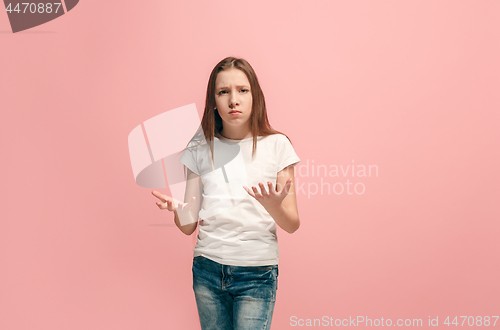 Image of Beautiful female half-length portrait on pink studio backgroud. The young emotional teen girl