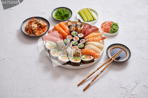 Image of Various sushi rolls placed on round ceramic plate