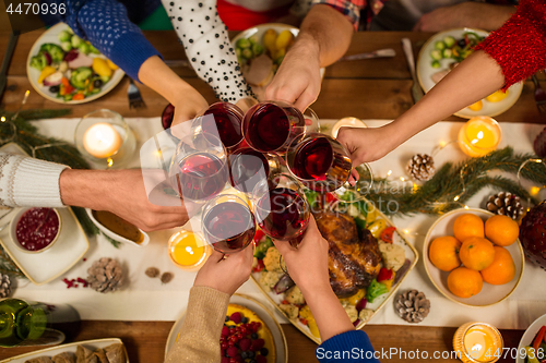 Image of close up of friends with wine celebrate christmas