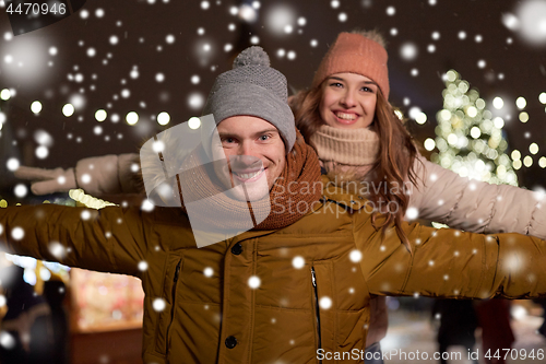 Image of happy couple having fun at christmas market