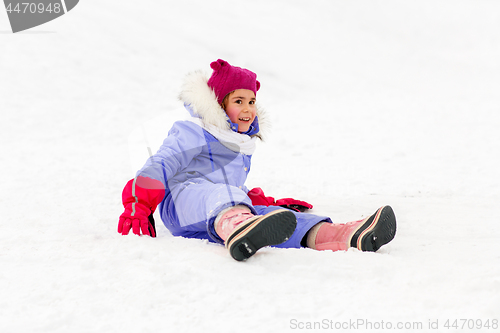 Image of happy little girl in winter clothes outdoors