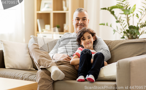 Image of happy father with little son at home