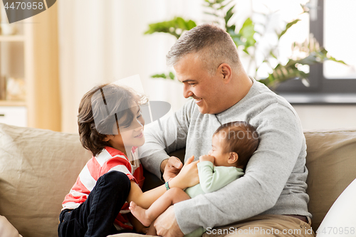 Image of happy father with preteen and baby son at home