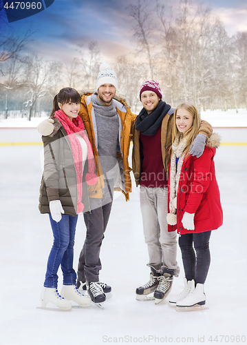 Image of happy friends on outdoor skating rink