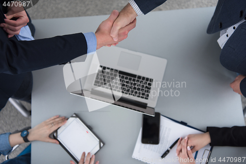 Image of cloasing the deal in modern office interior top view