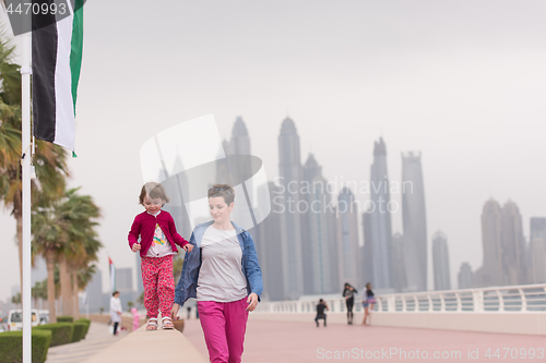 Image of mother and cute little girl on the promenade