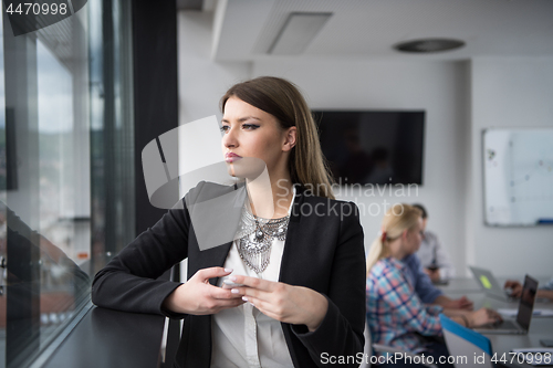 Image of Business Girl Standing In A Modern Building Near The Window With