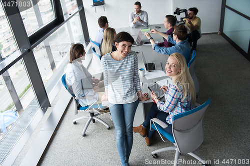 Image of Pretty Businesswomen Using Tablet In Office Building during conf