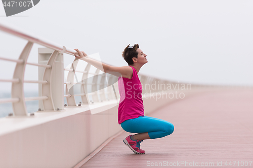 Image of woman stretching and warming up on the promenade