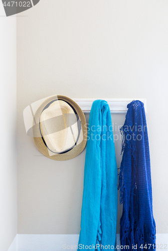 Image of Wall in House with Hat and Scarfs Hanging on Coat Rack Hooks Abs