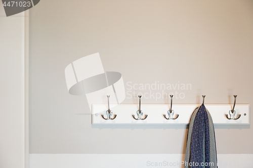 Image of Wall in House with Scarf Hanging on Coat Rack Hooks Abstract