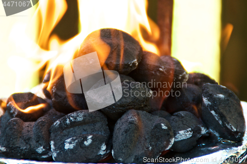 Image of Flaming BBQ briquettes at eye level