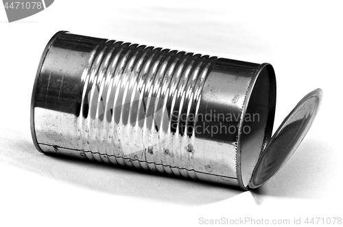 Image of large empty tin can on white laying down