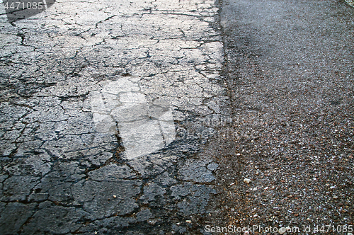 Image of dried cracked black asphalt roadway texture