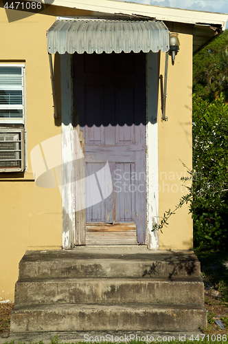 Image of rotting door on neglected building