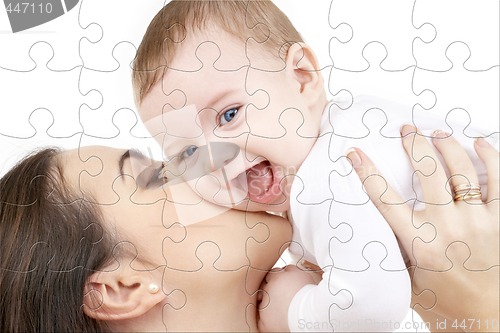 Image of laughing baby playing with mother puzzle