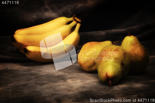 Image of bananas and pears on gray studio backdrop