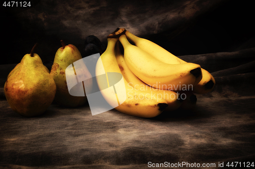 Image of pears and bananas on gray studio backdrop