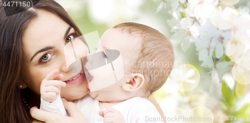 Image of close up of mother with baby over cherry blossoms