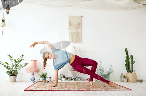 Image of young woman doing yoga at studio