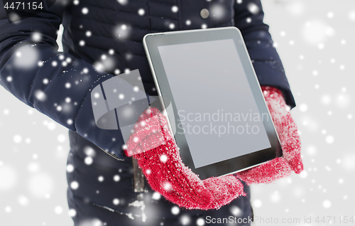 Image of close up of woman with tablet pc in winter