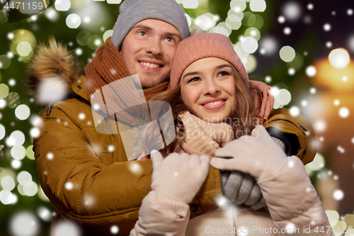 Image of happy couple hugging at christmas tree