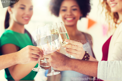 Image of friends clinking glasses of champagne at party