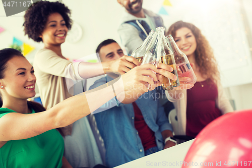 Image of happy team with drinks celebrating at office party