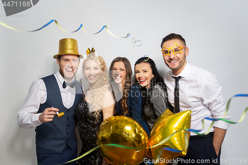 Image of friends with party props and confetti laughing