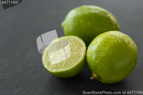 Image of close up of limes on slate table top