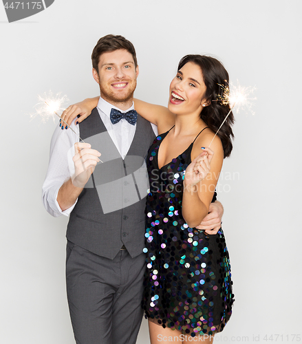 Image of happy couple with sparklers at party