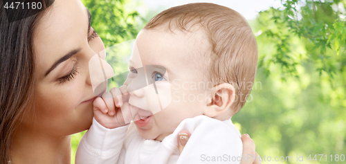 Image of mother with baby over green natural background