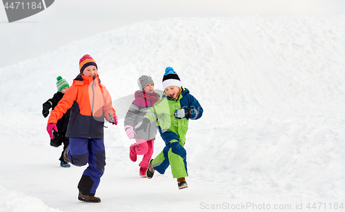 Image of happy little kids running outdoors in winter