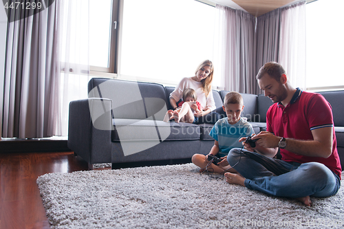 Image of Happy family playing a video game