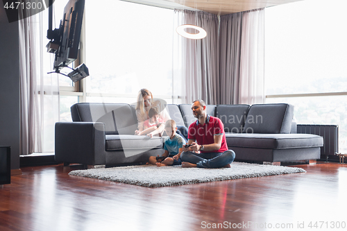 Image of Happy family playing a video game