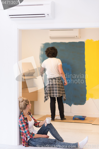 Image of young couple doing home renovations