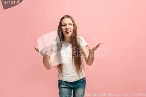 Image of Beautiful female half-length portrait on pink studio backgroud. The young emotional teen girl