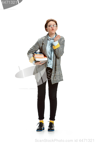 Image of Full length portrait of a happy smiling female student holding books isolated on white background