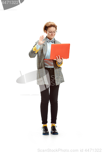 Image of Full length portrait of a happy smiling female student holding notebook isolated on white background