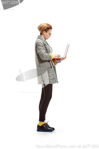 Image of Full length portrait of a happy smiling female student holding notebook isolated on white background