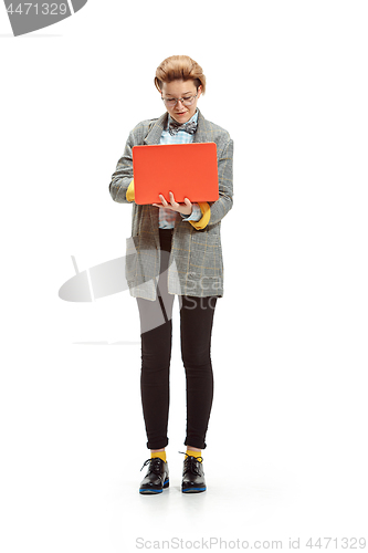 Image of Full length portrait of a happy smiling female student holding notebook isolated on white background