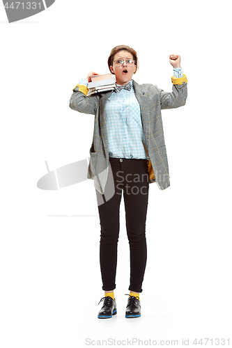 Image of Full length portrait of a happy smiling female student holding books isolated on white background