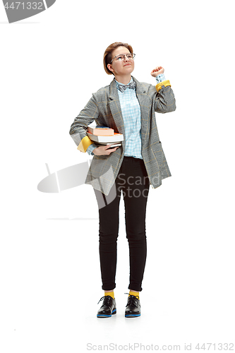 Image of Full length portrait of a happy smiling female student holding books isolated on white background