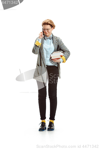 Image of Full length portrait of a unhappy female student holding books isolated on white background