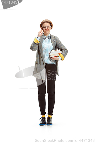 Image of Full length portrait of a happy smiling female student holding books isolated on white background