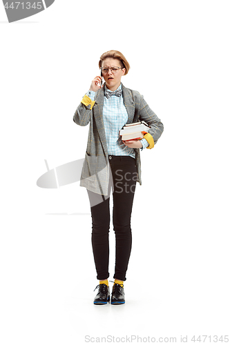 Image of Full length portrait of a happy smiling female student holding books isolated on white background